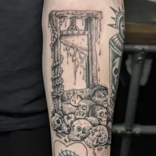 Blackwork guillotine skulls tattoo by @maisie.llewellyn