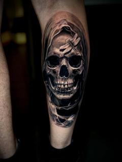 Realism hooded skull tattoo by @manic.tatts