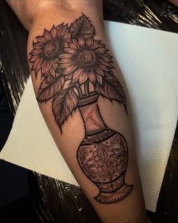 Blackwork sunflowers vase tattoo by @manishi_inkatattoo