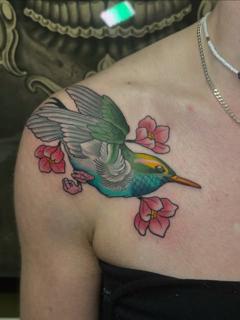 Traditional hummingbird with flowers tattoo by @mvrktattoo