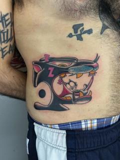 Anime cartoon character tattoo by @quipstertattoos