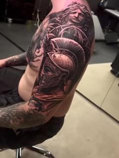 Realism spartan helmet statue tattoo by @markwosgerau