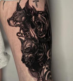 Realism cerberus dogs tattoo by @melina.tatts