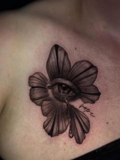 Realism crying eye flower tattoo by @melina.tatts