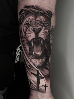 Realism lion and cross tattoo by @mitchmicallef