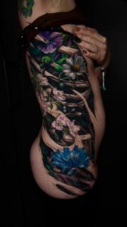 Realism floral vine tattoo by @moriel.seror