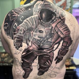 Realism astronaut tattoo by @nickfarbeyond