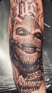 Realism masked figure tattoo by @nikosrodis