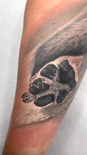 Realism dog paw tattoo by @noemikovacstattoo