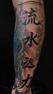 Japanese floral calligraphy tattoo by @oleg_narvski