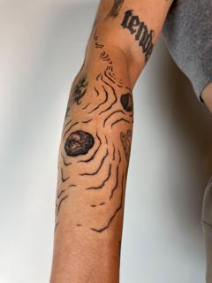 Fine line topographic lines tattoo by @tattoli__
