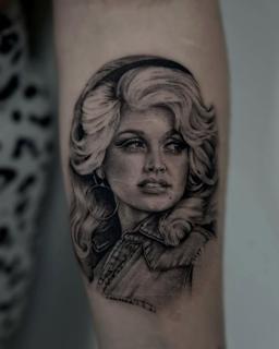 Realism dolly parton portrait tattoo by @tattoopaiges