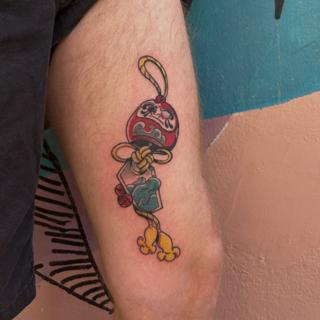 Traditional daruma doll tattoo by @buggietattoostudio