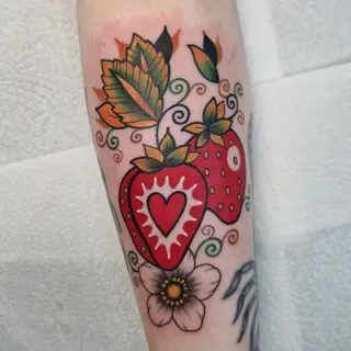 Traditional strawberry heart tattoo by @rabtattoo