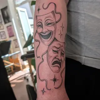 Traditional comedy tragedy masks tattoo by @inkleigh.tattoo