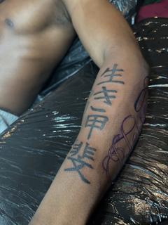Blackwork kanji script tattoo by @noka.tattoo