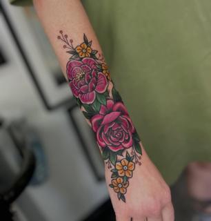Traditional floral bouquet tattoo by @robertcresswell28
