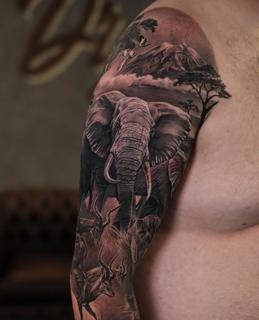 Realism elephant landscape tattoo by @rubentattooer