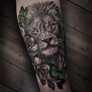 Realism black and grey with color accents lion roses butterflies tattoo by @startattooist