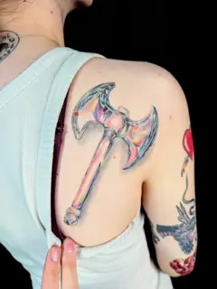 Realism iridescent axe tattoo by @sarahtattooos