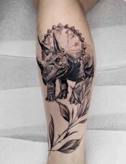 Illustrative triceratops dinosaur tattoo by @sean.dwyer.tattoo