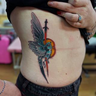 Neo-traditional bird sword tattoo by @shrddr_tattoo