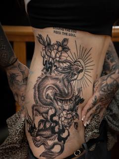 Blackwork dragon and flowers tattoo by @sherree_lionheart_tattoos