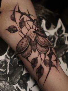 Blackwork moth and thorns tattoo by @sylvia__ink