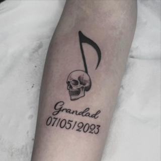 Illustrative skull music note tattoo by @tattooinestudios
