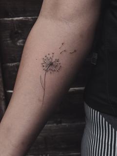 Fine line blowing dandelion tattoo by @terrie_titouutattoo