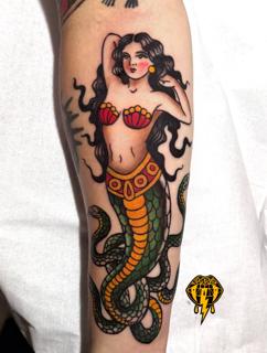 Traditional mermaid snake tattoo by @vasso_lowbrow