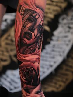 Realism clown woman rose tattoo by @inkbyroer