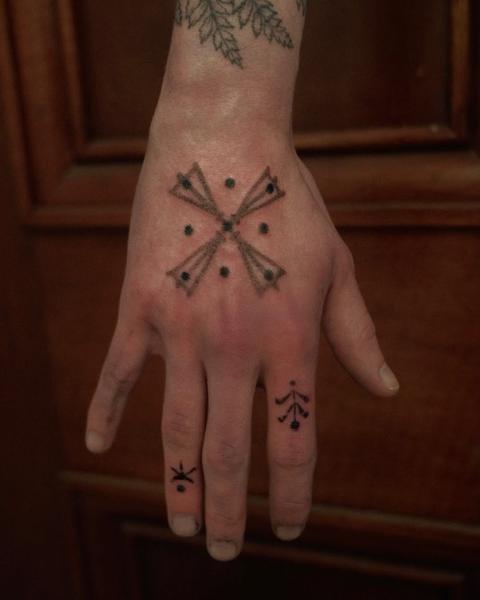 Dotwork geometric symbol tattoo by @2can.tattooer