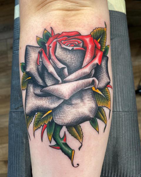 Traditional rose tattoo by @a_crockertattoo