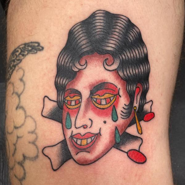 Traditional abstract face tattoo by @a_crockertattoo