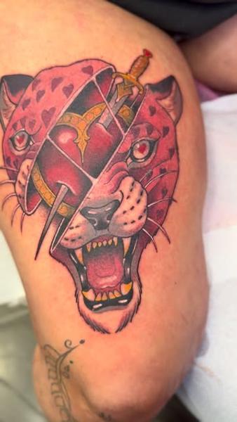 Traditional leopard heart dagger tattoo by @abishroom_tattoos