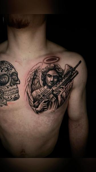 Realism angel with gun tattoo by @ablack_art