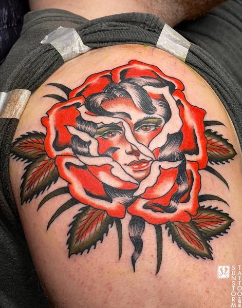 Traditional woman in rose tattoo by @sunstormtattoo