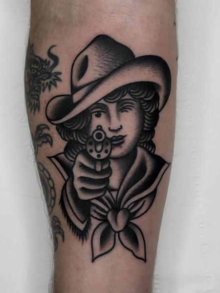 Traditional winking cowgirl tattoo by @hudsontattoo