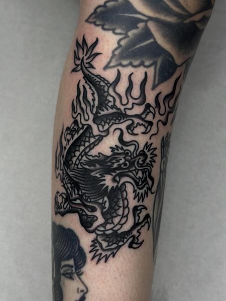 Blackwork flaming dragon tattoo by @hudsontattoo