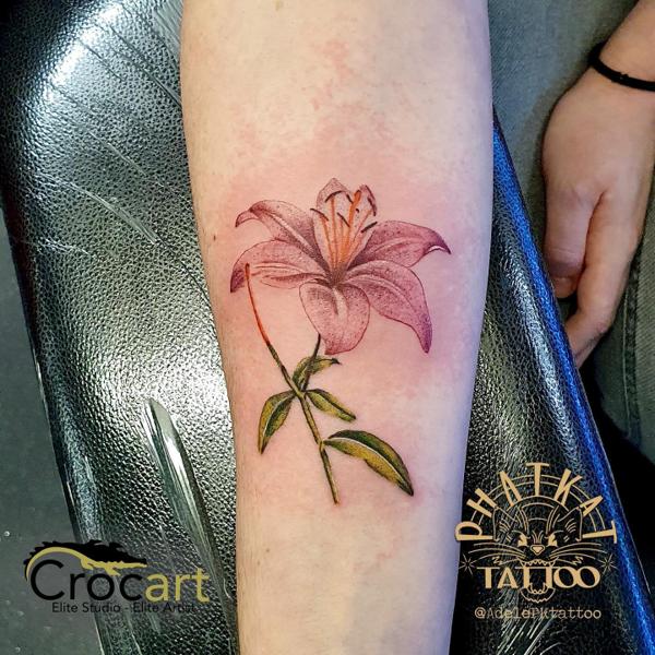 Realism lily flower tattoo by @adelepktattoo