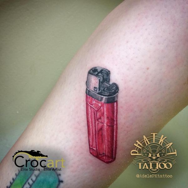 Realism red lighter tattoo by @adelepktattoo