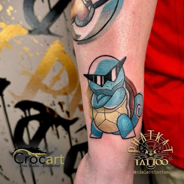 Cartoon squirtle character tattoo by @adelepktattoo