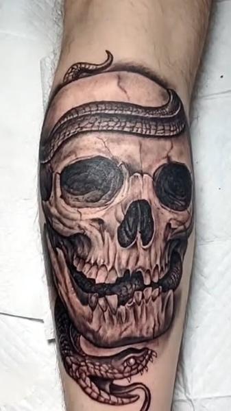 Realism snake skull tattoo by @ade_truemantattoo