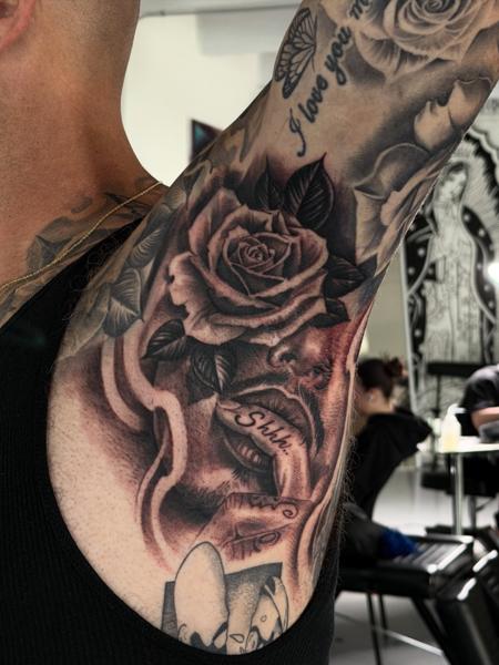 Realism rose and face tattoo by @adtattoos