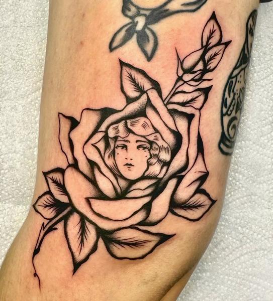 Traditional woman in rose tattoo by @gk._tattoo