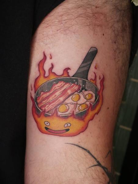 Anime calcifer cooking breakfast tattoo by @angiek.tattoo