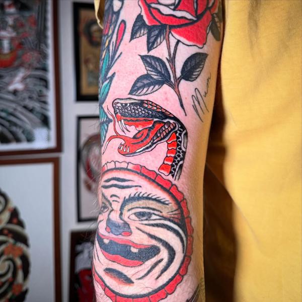 Traditional snake and face tattoo by @alberto_sagripanti