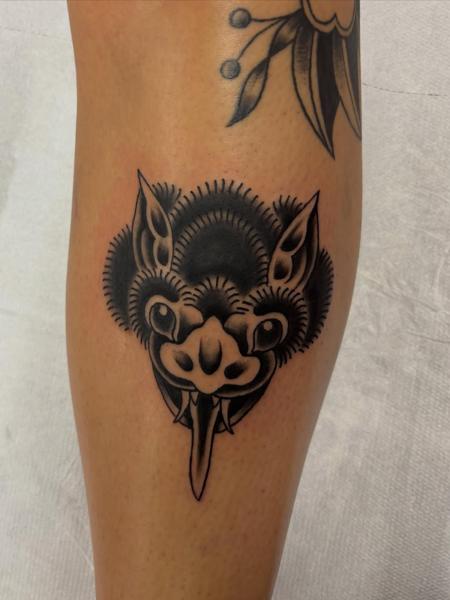 Traditional blackwork stylized monster head tattoo by @bratbabytattoo
