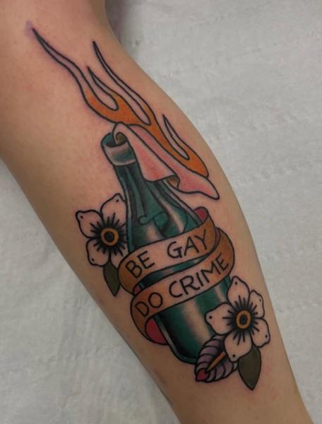 Traditional flaming bottle tattoo by @bratbabytattoo